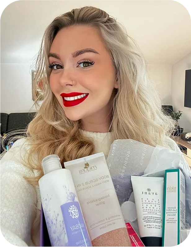 Smiling member holding skincare and beauty products
